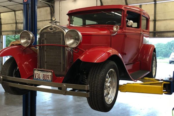 classic red Ford model A restored elevated in shop in Greenville IL